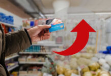 Beef Prices EXPLODE — Grocery Bills Out of Control Hand holding credit cards with red upward arrow