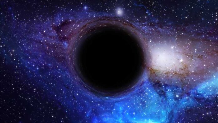 shutterstock_2354932545.jpg A black hole surrounded by a colorful galaxy filled with stars