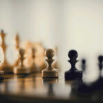 Chess pieces on a board blurred background