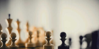 Chess pieces on a board blurred background