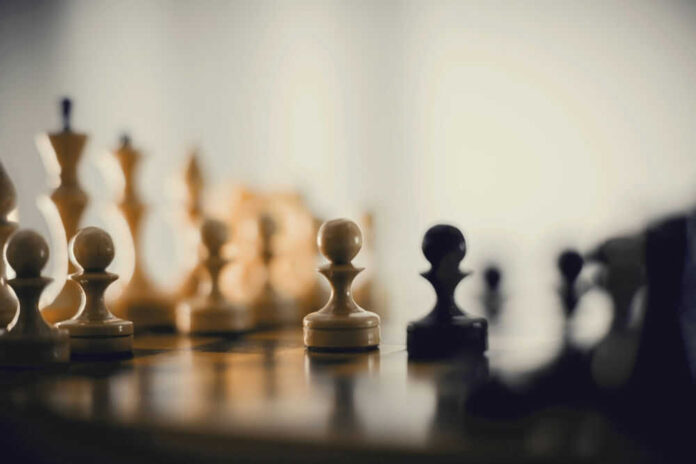 Chess pieces on a board blurred background