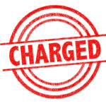 Ex-Pro QB Faces Criminal Charges Red charged stamp with circular border