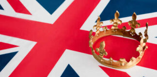 A golden crown resting on the Union Jack flag