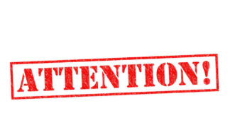 Red attention stamp on white background