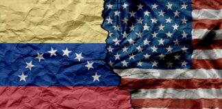 Crumpled flags of Venezuela and the United States split in the center