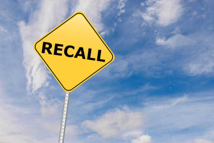 shutterstock_529192612.jpg Yellow sign with RECALL text against blue sky.
