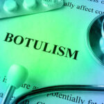 Close-up of a document about botulism with a stethoscope and pills