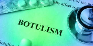 Close-up of a document about botulism with a stethoscope and pills