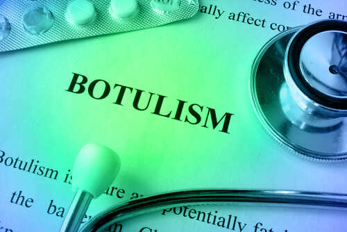 Close-up of a document about botulism with a stethoscope and pills