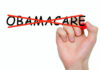 Hand crossing out the word Obamacare in red