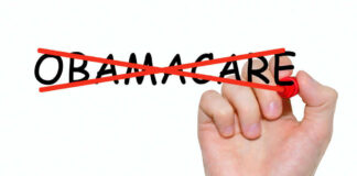 Hand crossing out the word Obamacare in red