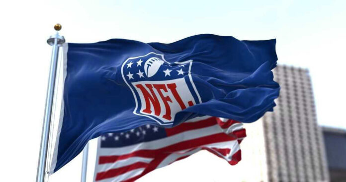 NFL flag waving beside American flag.