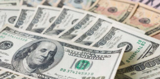 Stacks of various U.S. dollar bills.