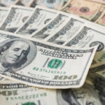 Stacks of various U.S. dollar bills.