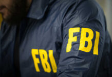 Pipe Bomb Confession Shocks FBI FBI agent in navy blue jacket.
