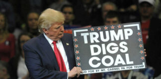 Donald Trump holding sign saying Trump Digs Coal