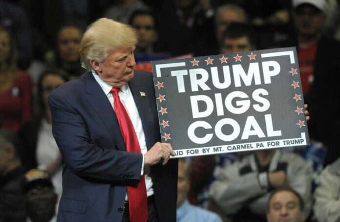 Donald Trump holding sign saying Trump Digs Coal