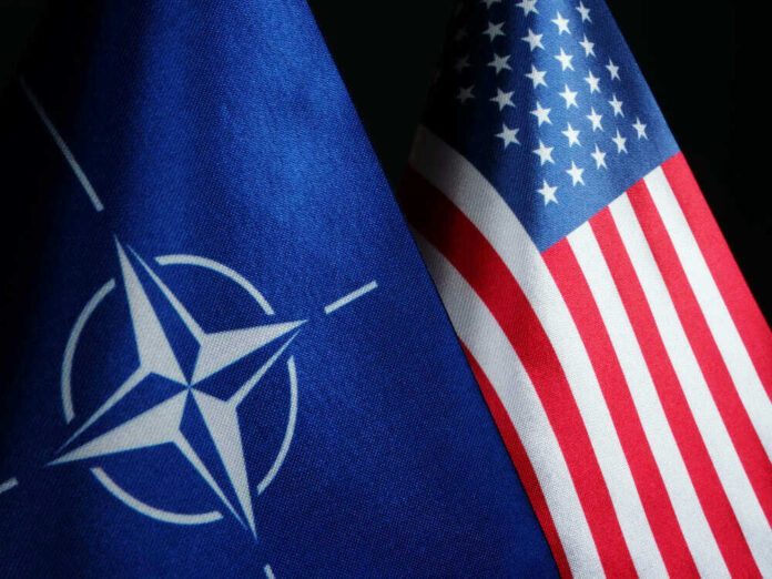 shutterstock_1511622704.jpg NATO flag and United States flag side by side.