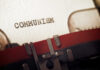 Close-up of a typewriter with the word 'COMMUNISM' typed on paper