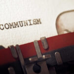 Arctic Plot REVEALED — Commies Targeting America Close-up of a typewriter with the word 'COMMUNISM' typed on paper