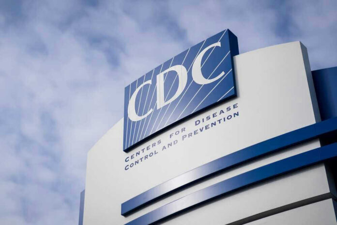 CDC building sign against a cloudy sky.