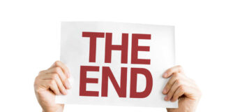 Hands holding a sign that reads 'THE END'