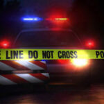 SHOCKING Double Hit-and-Run Kills Former Child Star Police car with flashing lights behind caution tape.