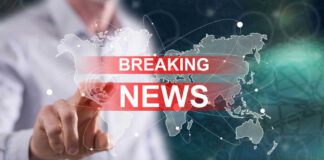 Breaking news graphic over world map background.