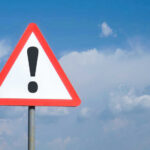 Vonn’s Defiant Move — Will She Pull It Off? Triangle warning sign with exclamation mark against sky.