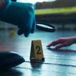 OUTRAGE: Bar Owner EXECUTED After Handing Over Cash A detective examining evidence at a crime scene with markers on the floor