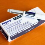 Wegovy injectable pen and its packaging on a wooden surface