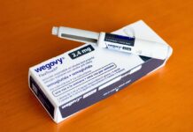Wegovy injectable pen and its packaging on a wooden surface