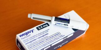 Wegovy injectable pen and its packaging on a wooden surface