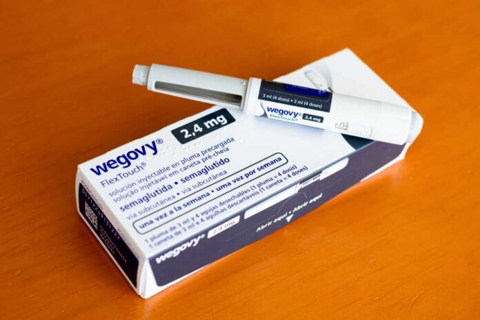 Wegovy injectable pen and its packaging on a wooden surface