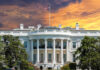 White House SPINS Weak Jobs as Immigration Win The White House with vibrant sunset sky.