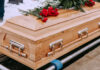 Supermodel’s Death Saddens Fans Wooden casket with red roses on top
