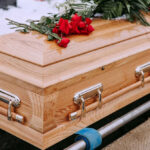 Supermodel’s Death Saddens Fans Wooden casket with red roses on top