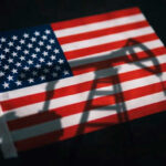 American flag with oil pump shadow overlay.