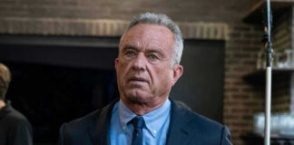 Robert F Kennedy JR in suit indoors.