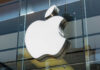 Apple logo displayed prominently on a glass storefront