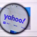 Yahoo! Search Vanishes—End Of An Era Magnifying glass focusing on the Yahoo website logo
