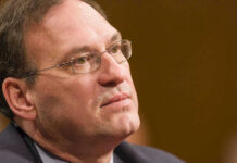 Alito vs. Jackson — BRUTAL Exchange at the Supreme Court Close-up of a man wearing glasses, looking thoughtful.