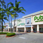 Exterior view of a Publix grocery store with palm trees