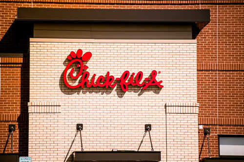 Chick-fil-A restaurant sign on a brick wall