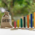 Debt Bomb Ticks — Banks Sound Alarm Debt sack with rising financial graph bars.