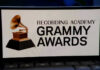 Hit Machine Silenced — Stars Scramble Grammy Awards logo on a smartphone screen.
