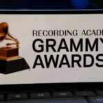 Hit Machine Silenced — Stars Scramble Grammy Awards logo on a smartphone screen.