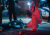 Bloody Weekend, Rising Death Toll Forensic investigator examines crime scene at night.