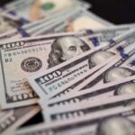 Close-up of scattered hundred dollar bills