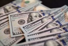 Close-up of scattered hundred dollar bills